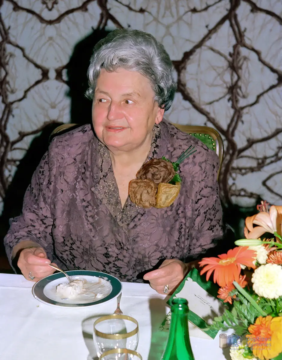 An elderly lady enjoying a cake