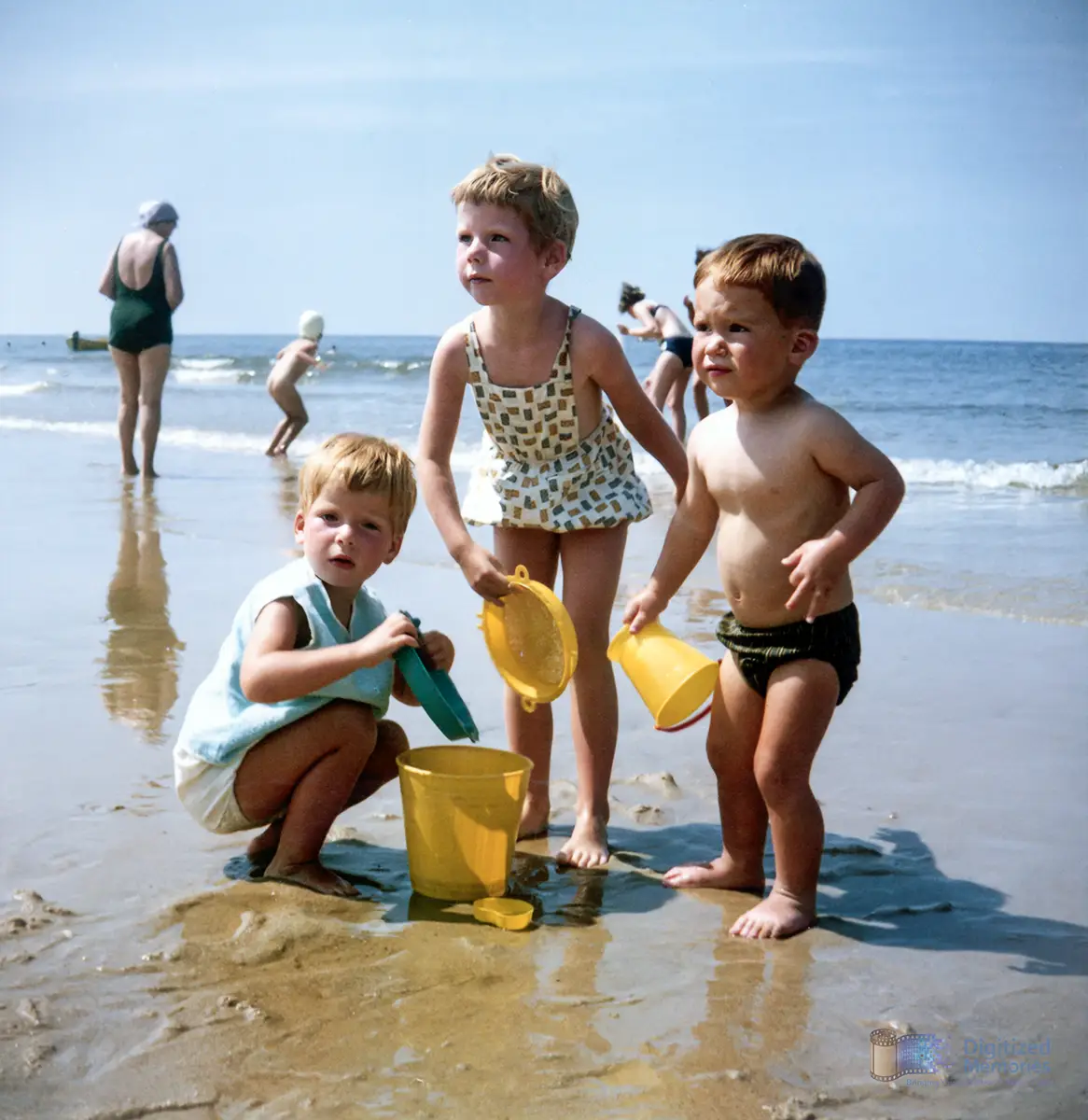 Three children playing on a beach