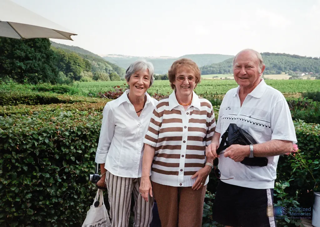 Photo of three people with a green nature background